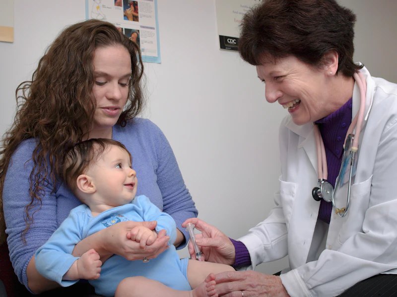 Doctor with a mother and baby